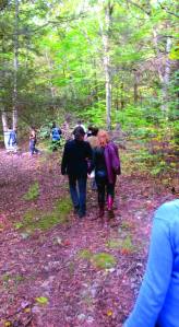 Players hike through the woods to the site where game-play will begin.  (Photo: Liz Rywelski)