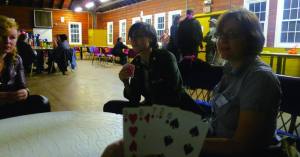 While waiting for their interviews, characters bide their time conversing in small groups or playing card games.  (Photo: Liz Rywelski)