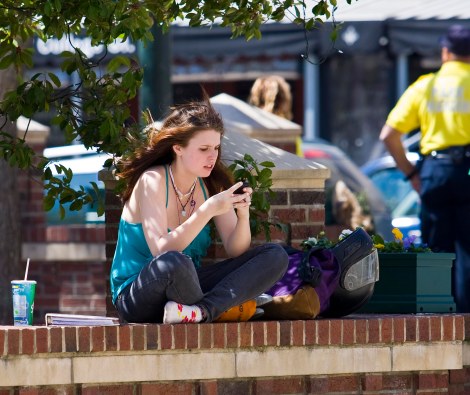 She could be accessing porn! In broad daylight! On her phone! And her parents would never even know!!! (Photo copyright Jeffrey Pott.)