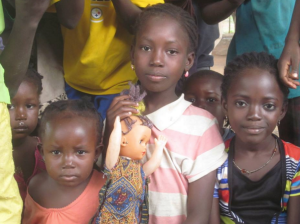 These little girls modified a second-hand blonde doll, giving her braids and traditional clothing.